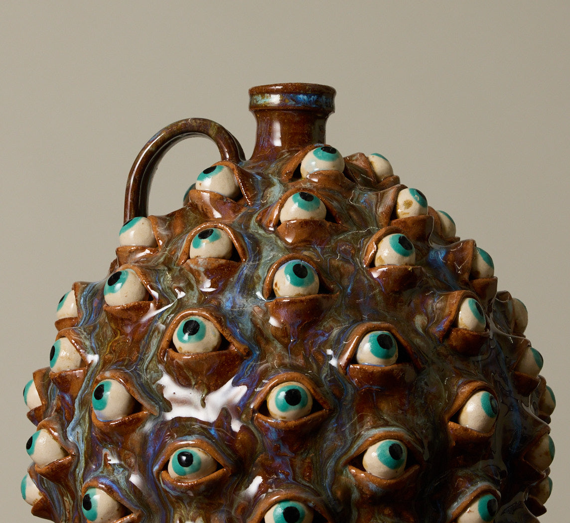 20TH CENTURY FOLK ART POTTERY EYEBALL JUG