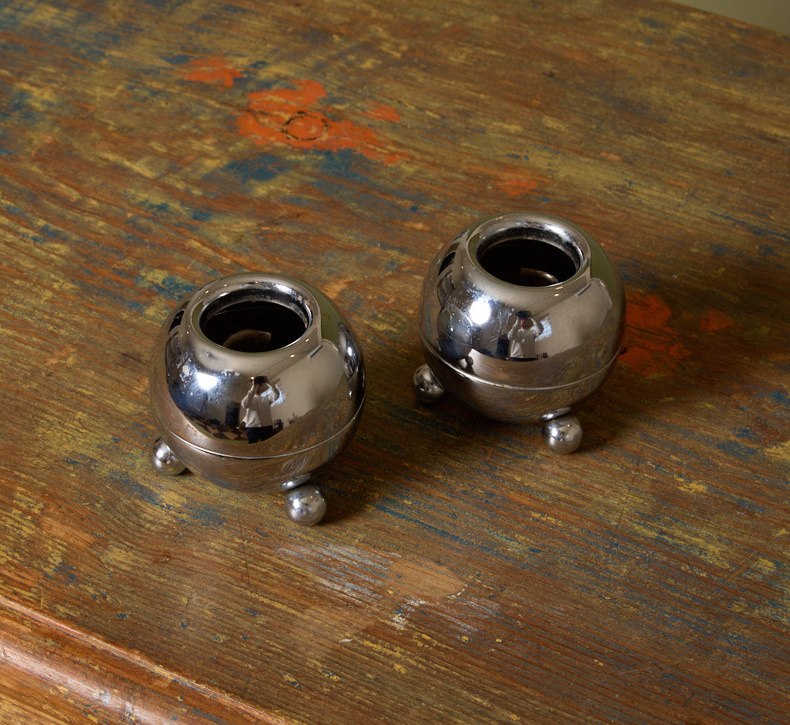 PAIR OF MIDCENTURY FOOTED ORB CHROME CANDLESTICK HOLDERS