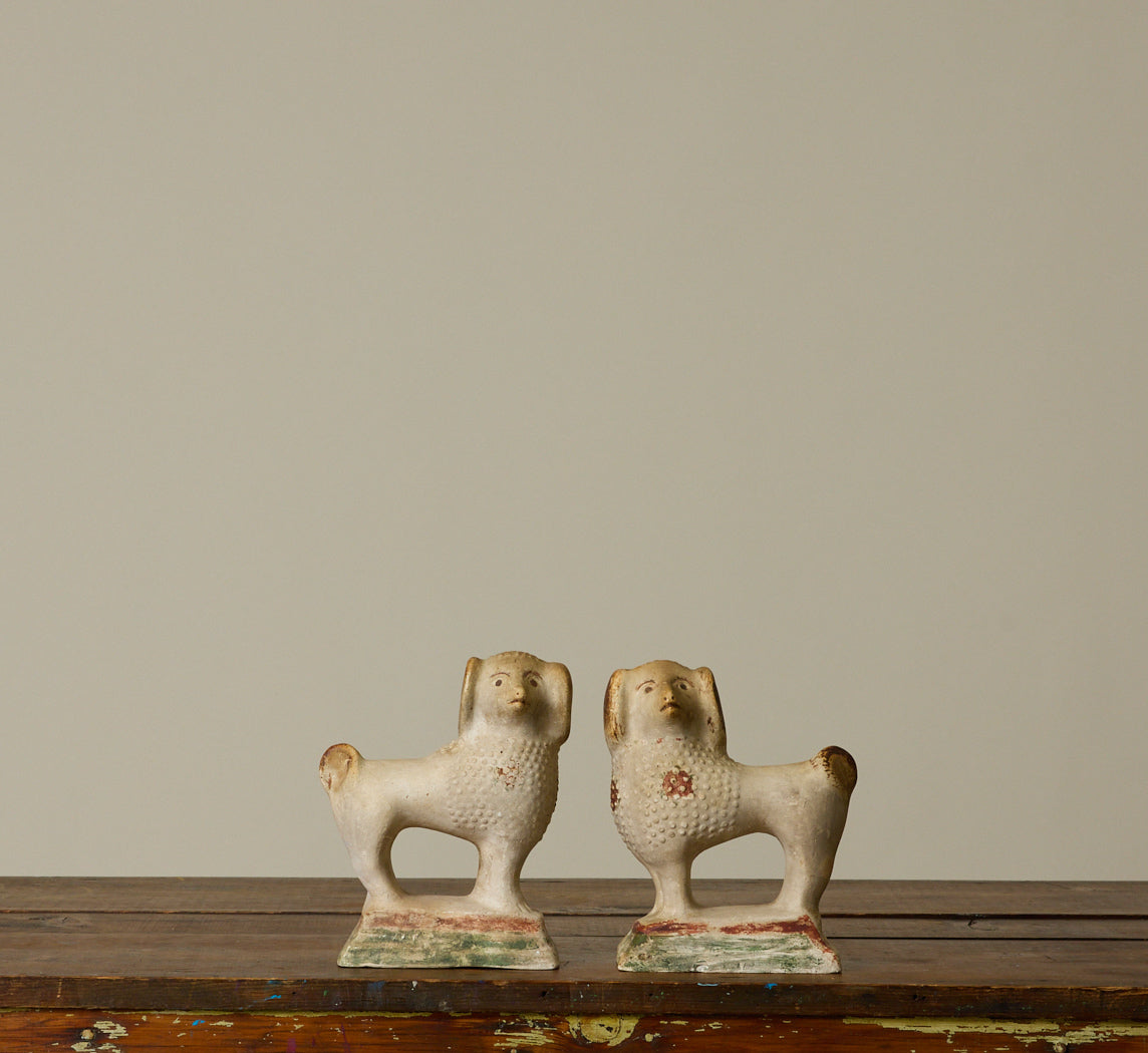PAIR OF 19TH CENTURY AMERICAN CHALKWARE POODLE FIGURINES