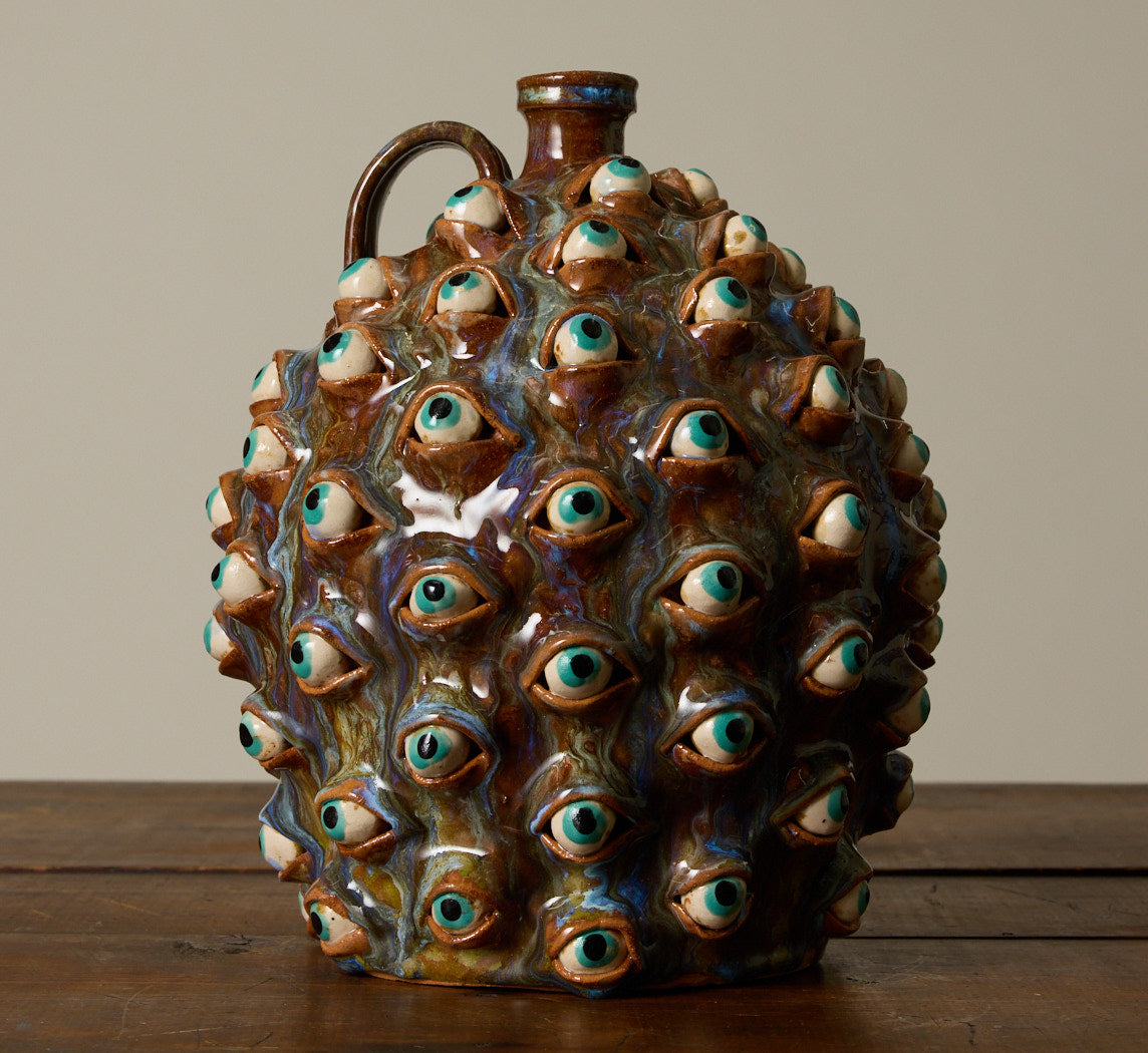 20TH CENTURY FOLK ART POTTERY EYEBALL JUG