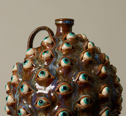 20TH CENTURY FOLK ART POTTERY EYEBALL JUG