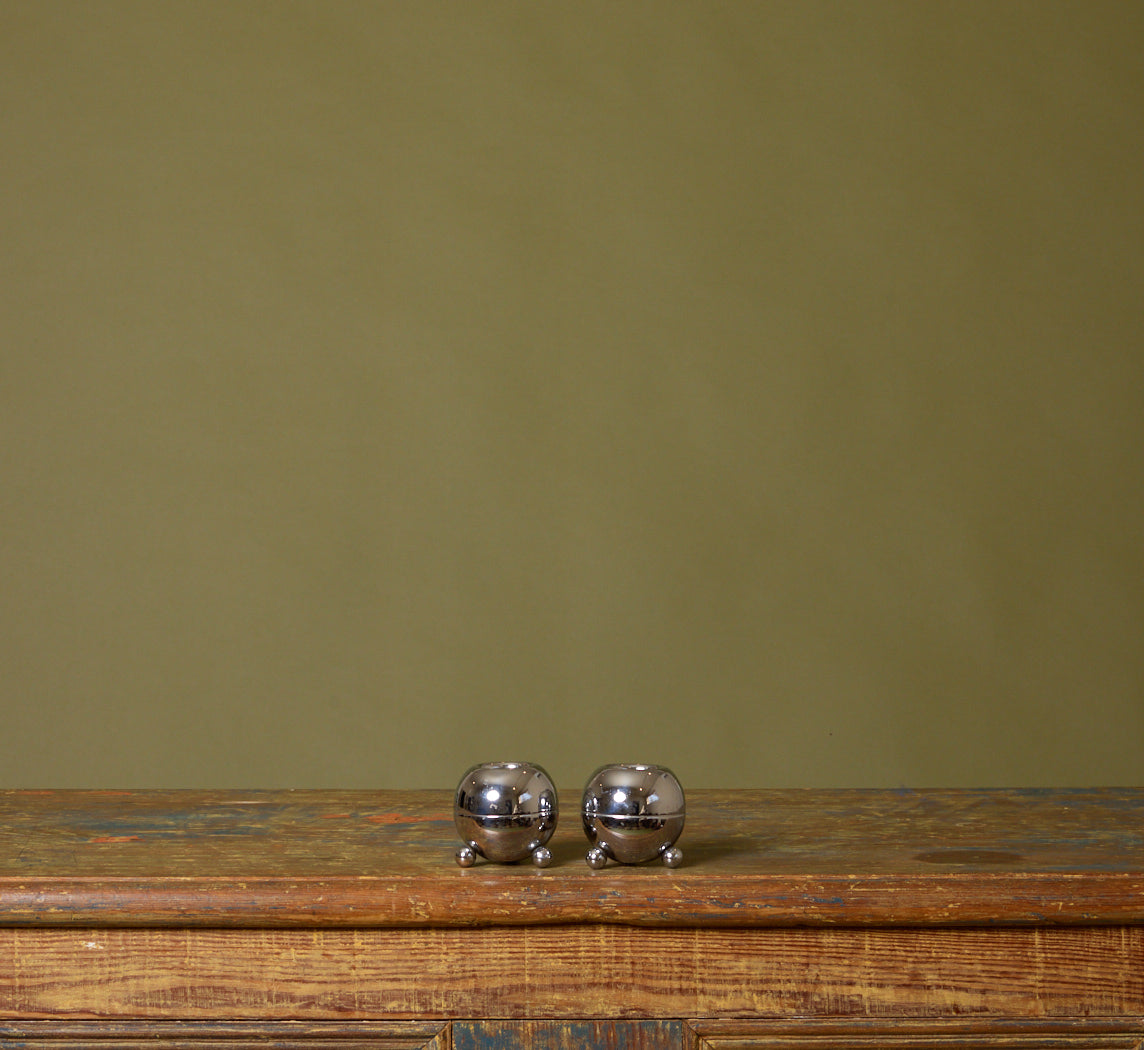 PAIR OF MIDCENTURY FOOTED ORB CHROME CANDLESTICK HOLDERS