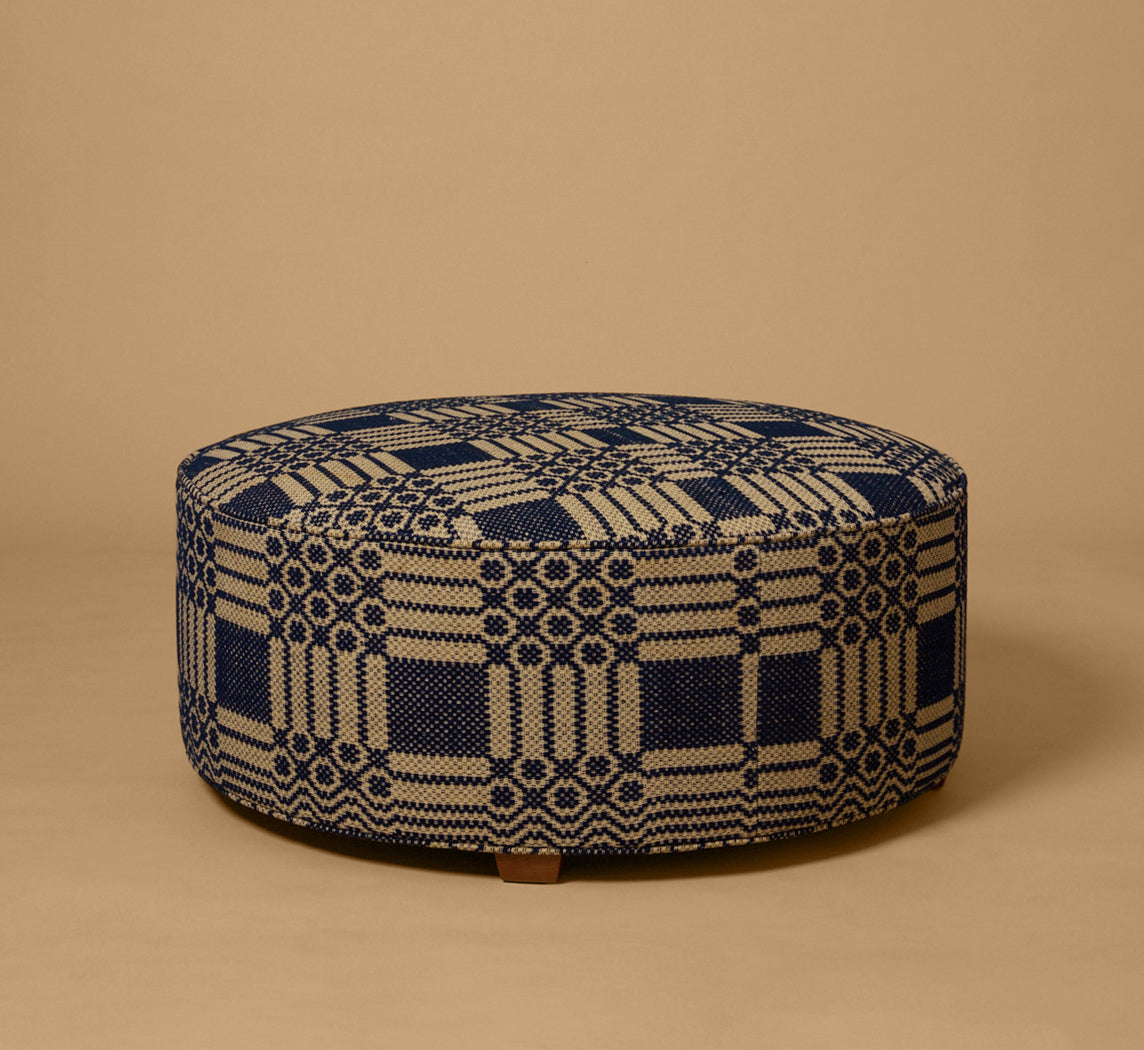 PIERCE & WARD CIRCLE OTTOMAN IN ANTIQUE AMERICAN COVERLET