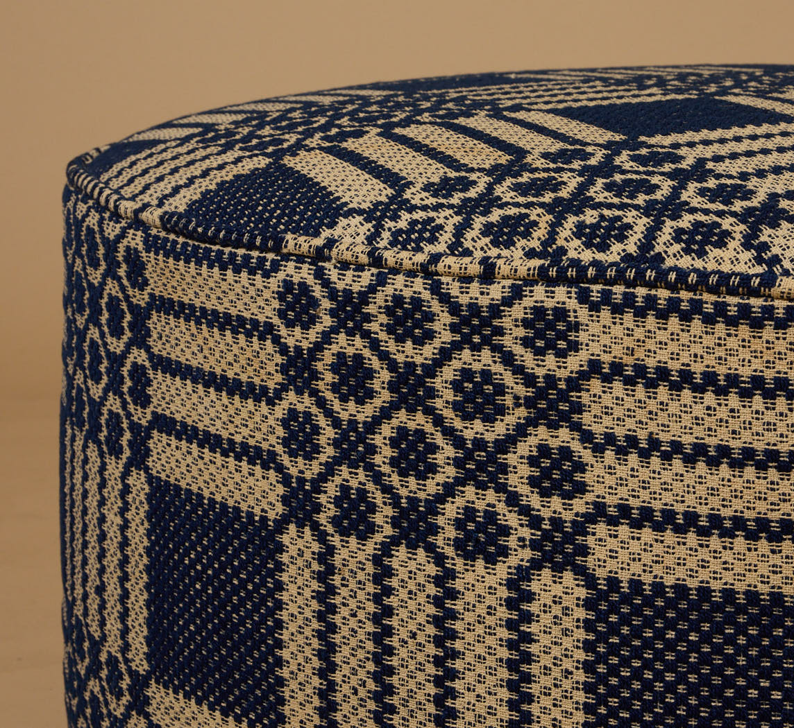 PIERCE & WARD CIRCLE OTTOMAN IN ANTIQUE AMERICAN COVERLET