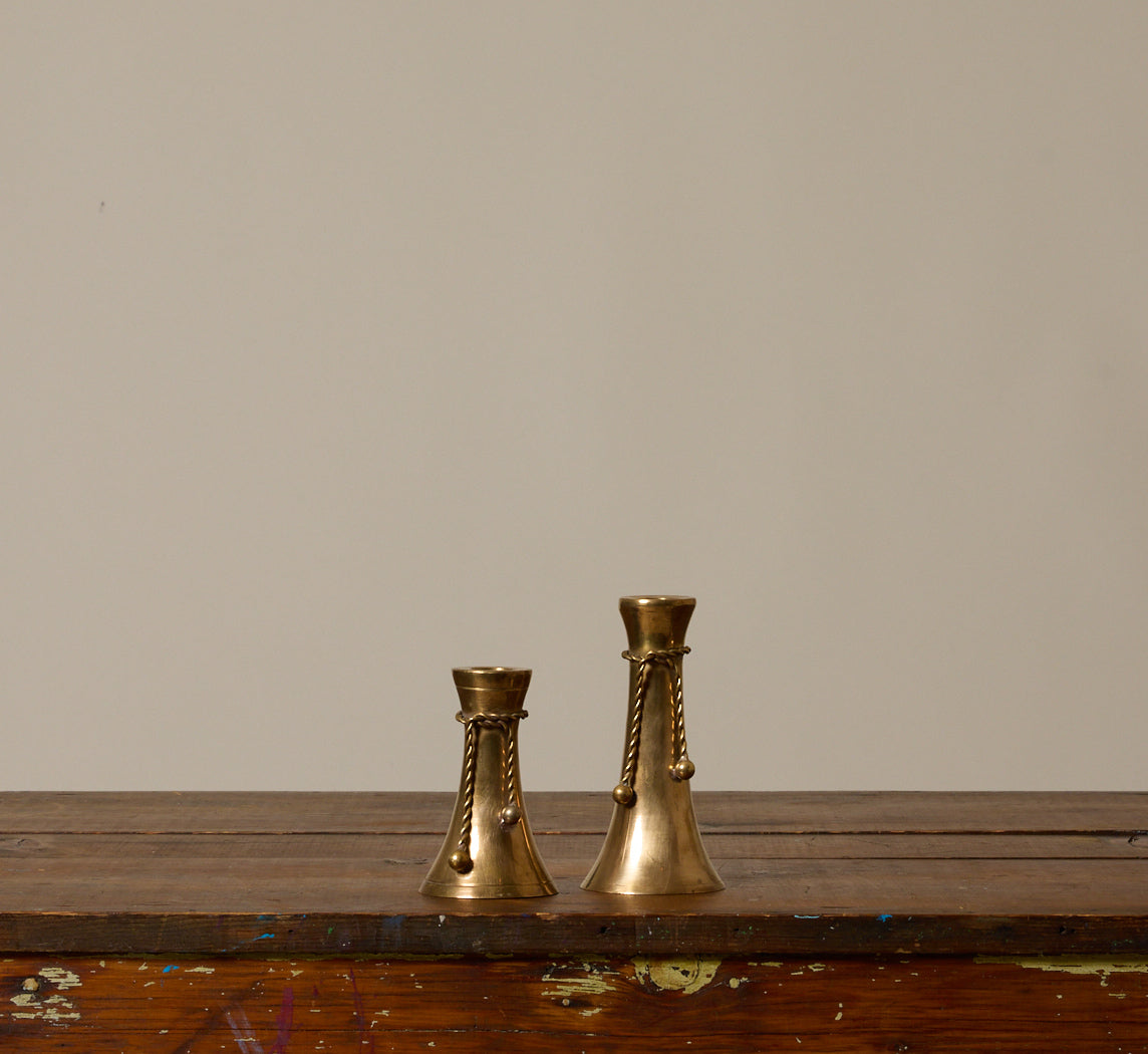PAIR OF ASYMMETRICAL BRASS TASSEL CANDLESTICK HOLDERS