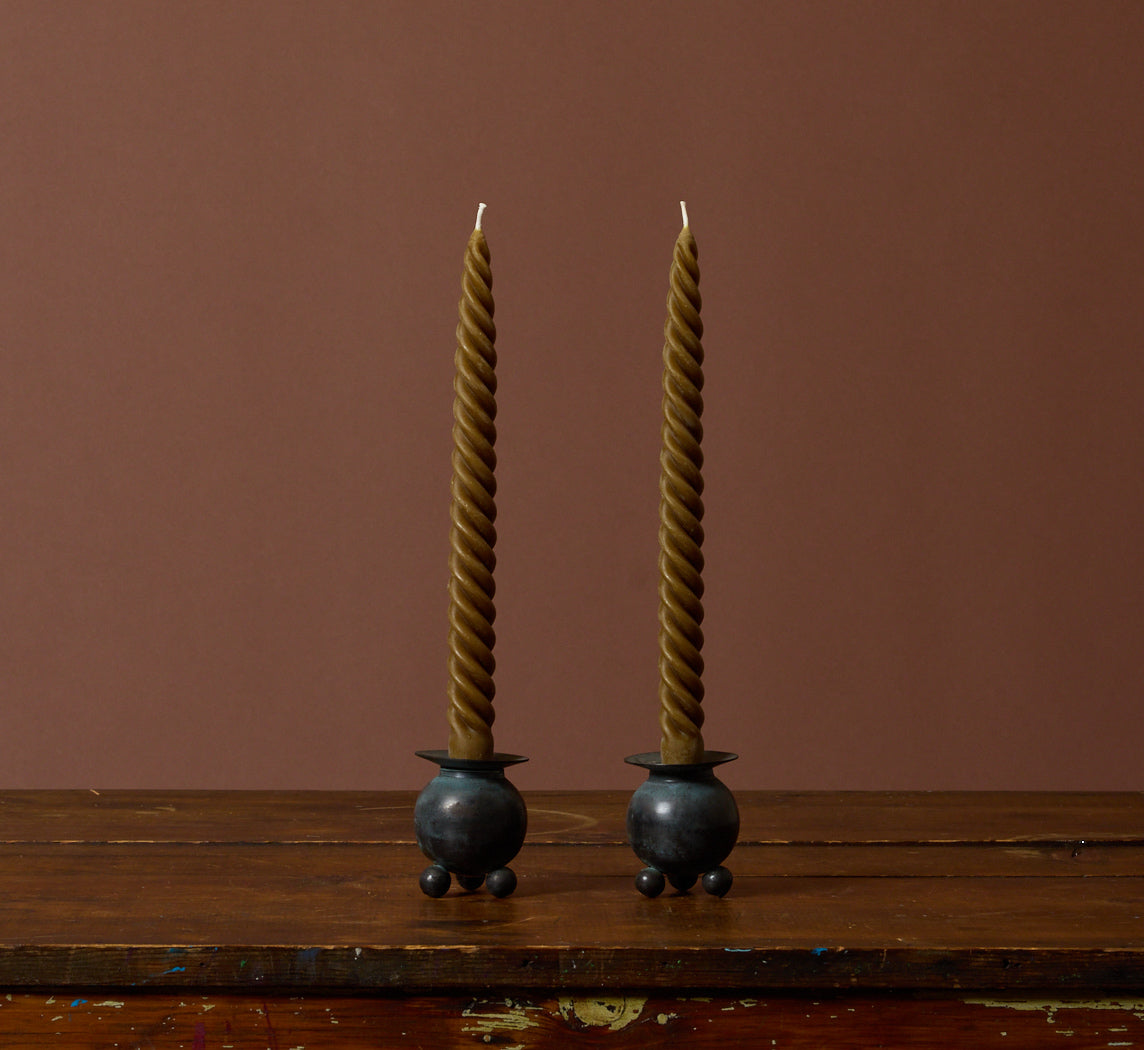 PAIR OF VINTAGE PATINATED FOOTED ORB CANDLESTICK HOLDERS