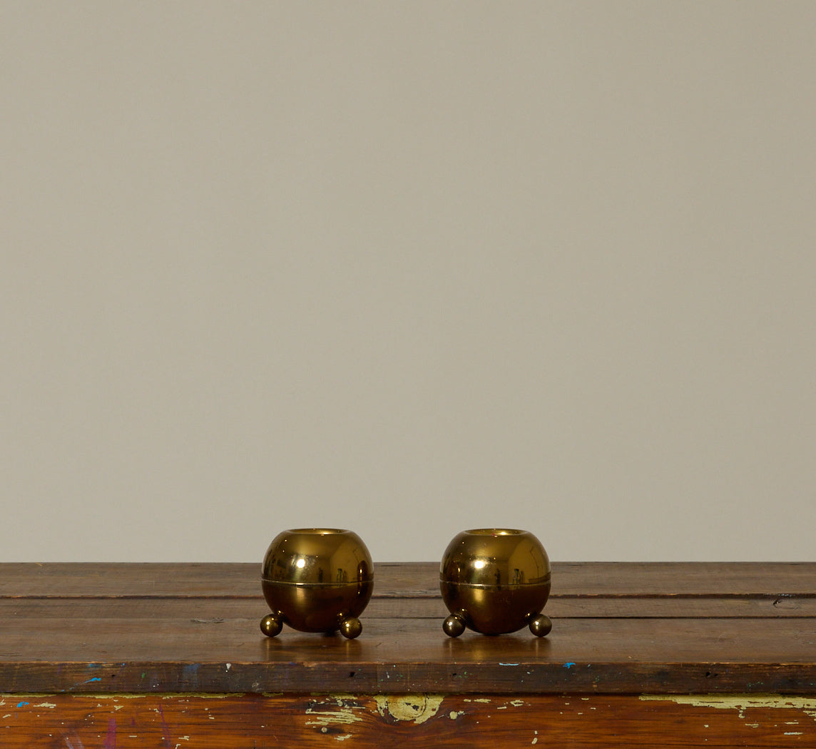 PAIR OF MID CENTURY FOOTED ORB BRASS CANDLESTICK HOLDERS II