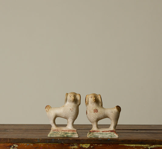 PAIR OF 19TH CENTURY AMERICAN CHALKWARE POODLE FIGURINES
