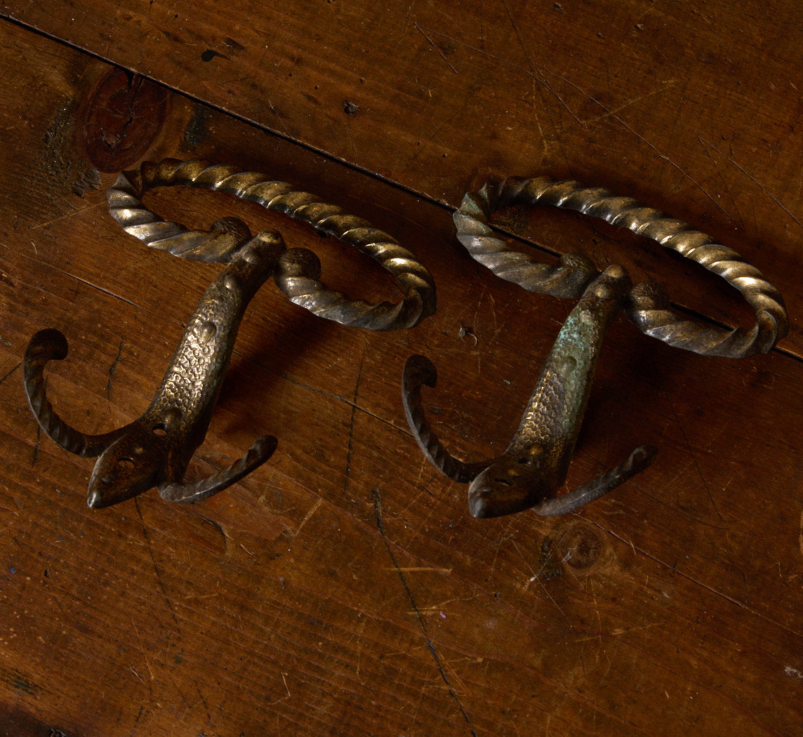 PAIR OF ANTIQUE CAST IRON WALL HOOKS