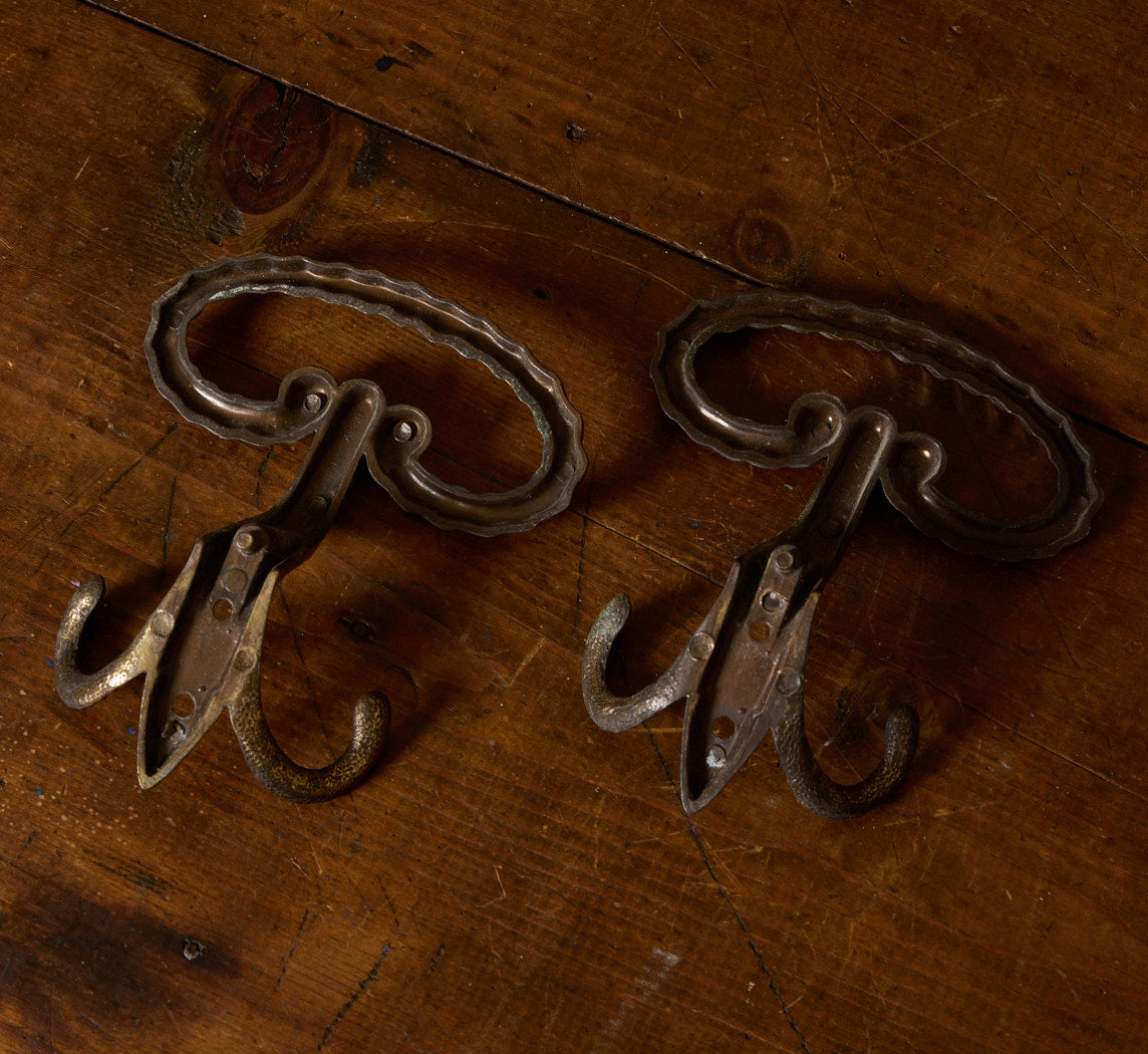 PAIR OF ANTIQUE CAST IRON WALL HOOKS